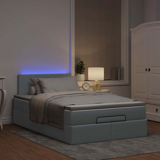 Ottoman bed met matras en LED's 120x190 cm stof lichtgrijs